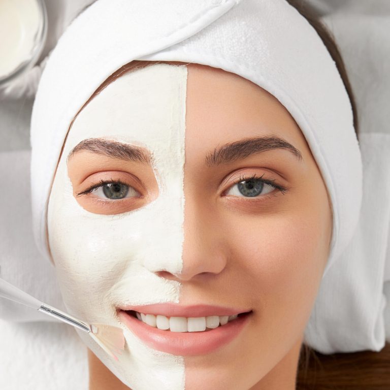 Top view portrait of attractive smiling young woman on cleaning face in beautician. Concept of special procedure for improvements and rejuvenation skin in professional beauty salon.